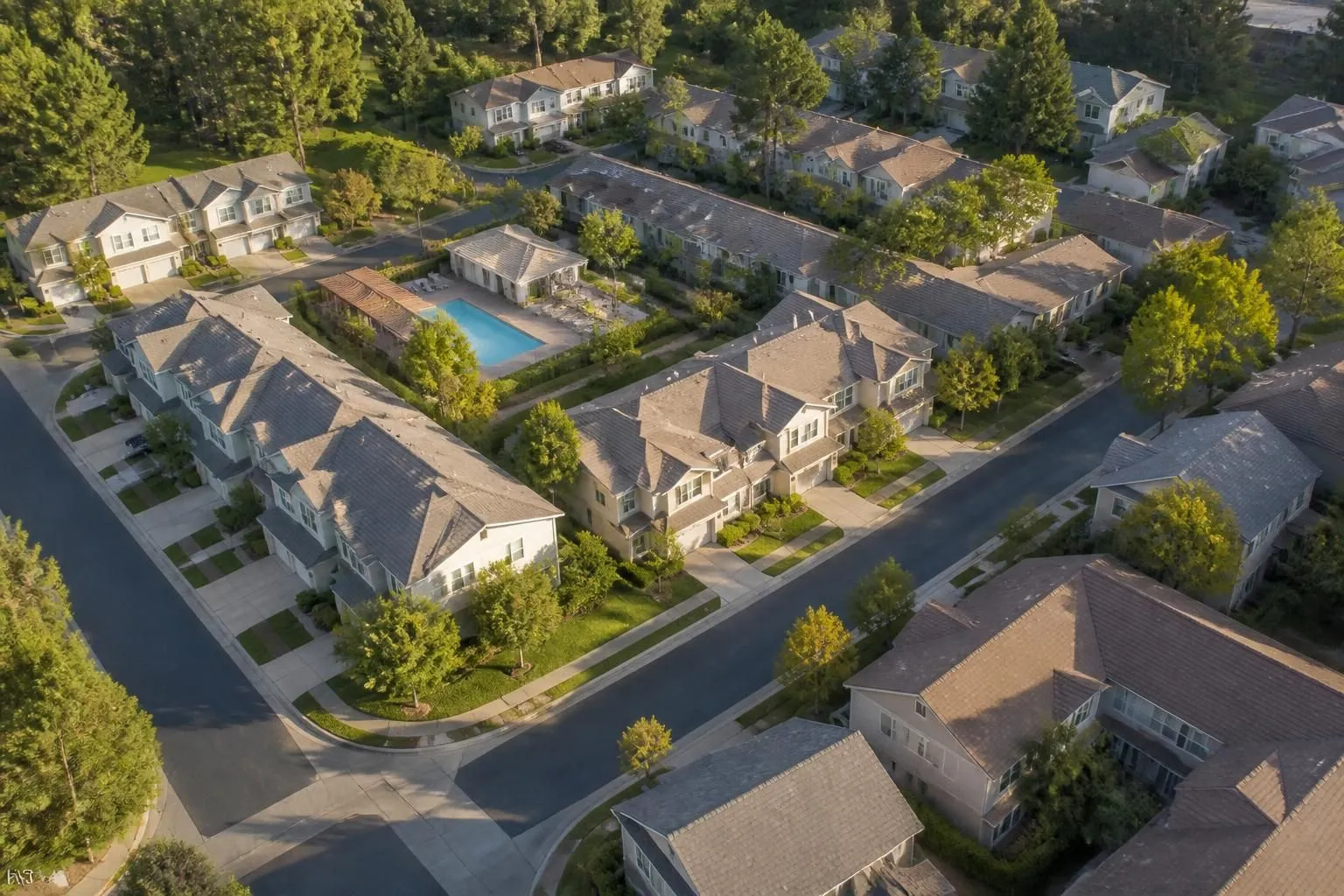 Reserve components from above: shingle roofs, a pool and pool house, drives, sidewalks and parking, the kind of inventory a reserve study prices and schedules.