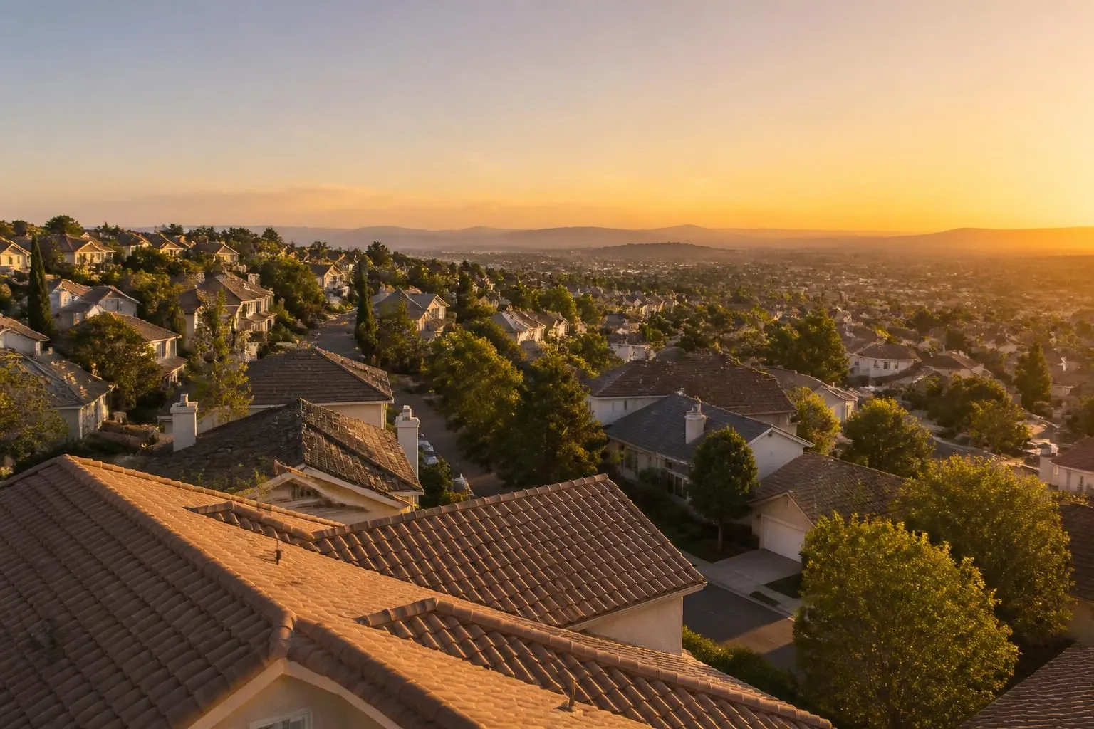 Roof coverings across a community at low sun, when slope, wear and ponding read most clearly, which is why roof capture is scheduled for it.